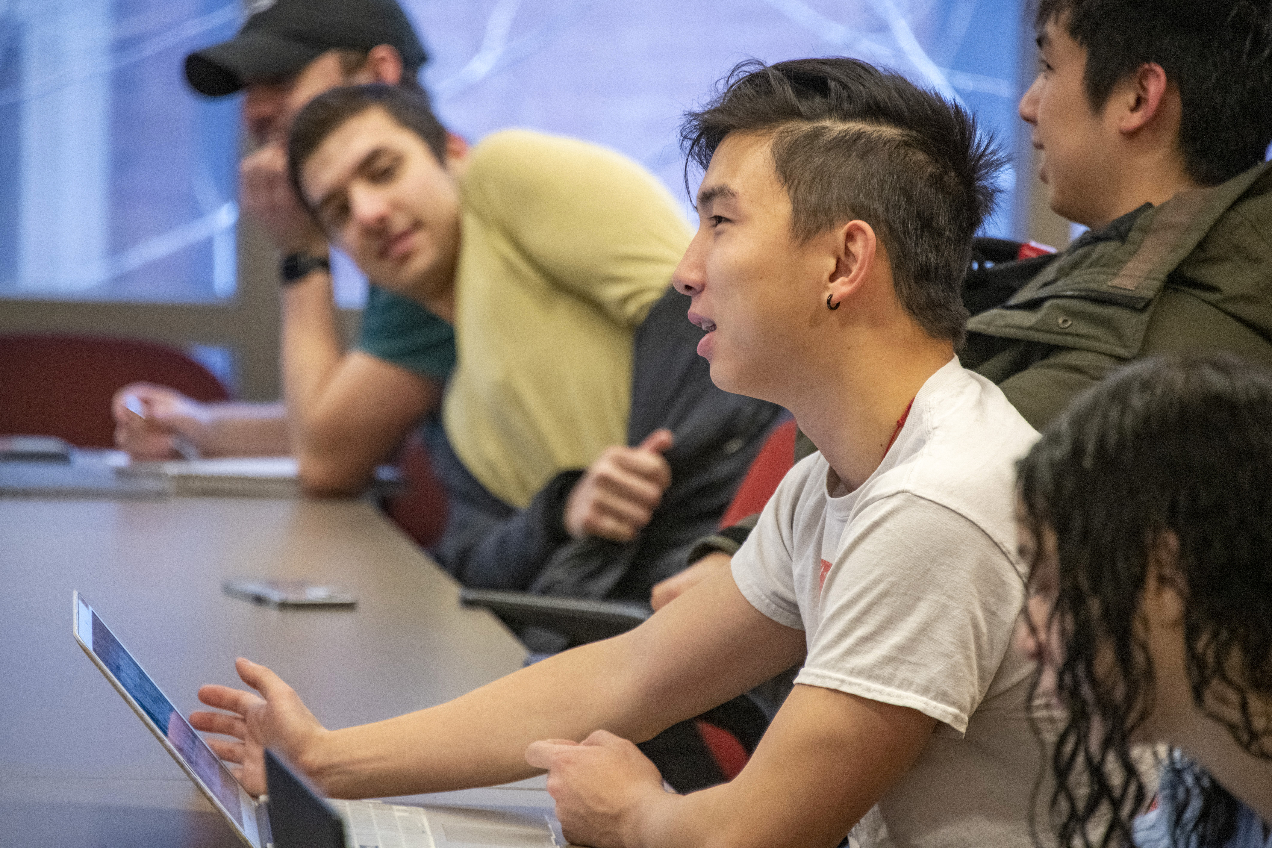 Student sitting at laptop, participating in lecture